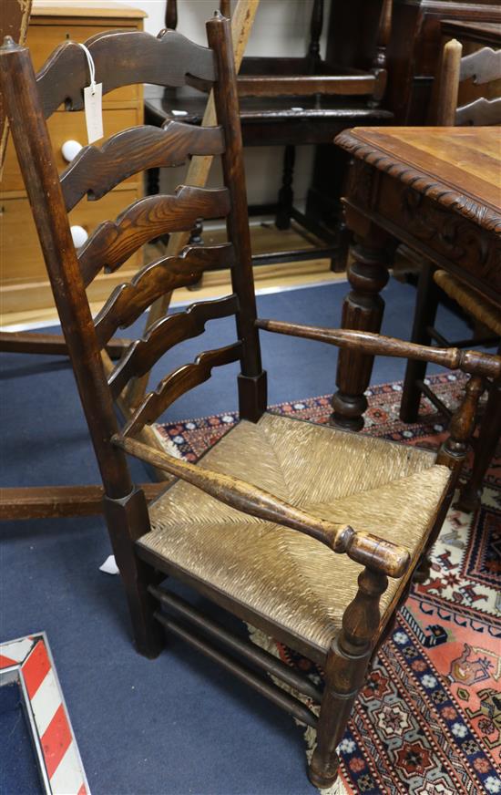 A set of six ladderback dining chairs with a similar carver